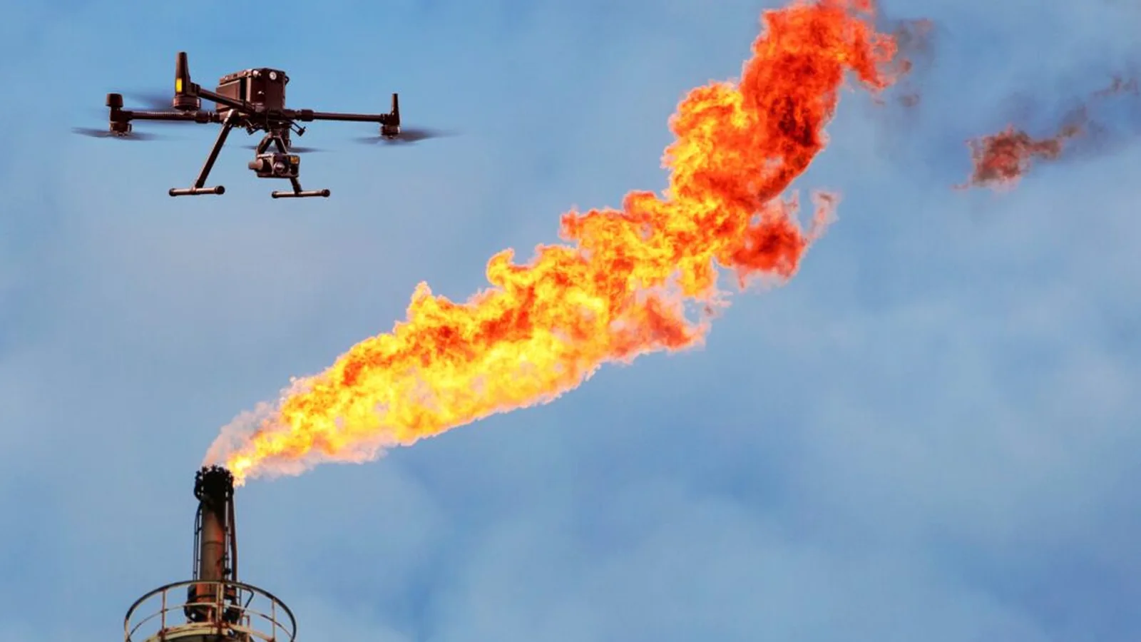 Drone inspecting a burning flare stack
